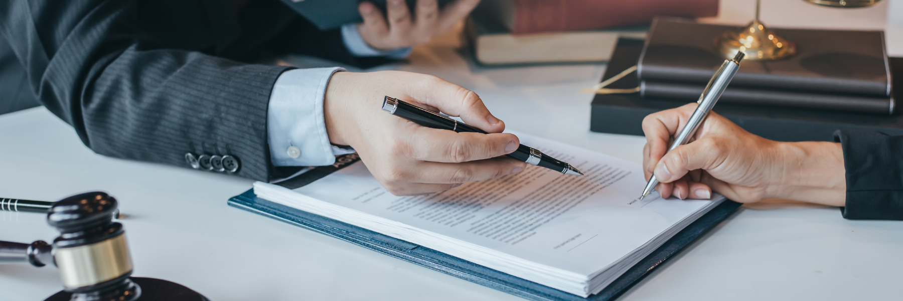 Photo of an attorney and a client reviewing a document to represent the work of North Carolina Trust Litigation Attorneys